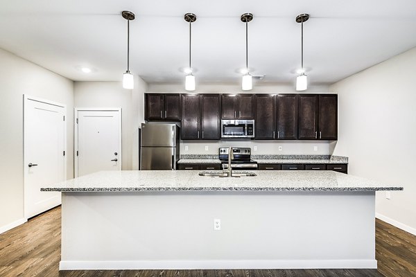 Modern kitchen with stainless steel appliances at Parkside at Avalon Park Apartments