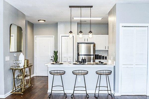 Modern kitchen with stainless steel appliances in Parkside at Avalon Park Apartments
