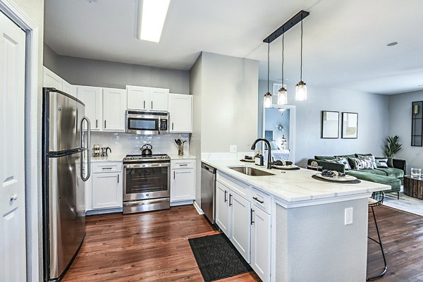 Modern kitchen with stainless steel appliances at Parkside at Avalon Park Apartments