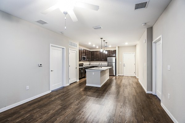 Spacious living room with modern decor and natural light at Parkside at Avalon Park Apartments