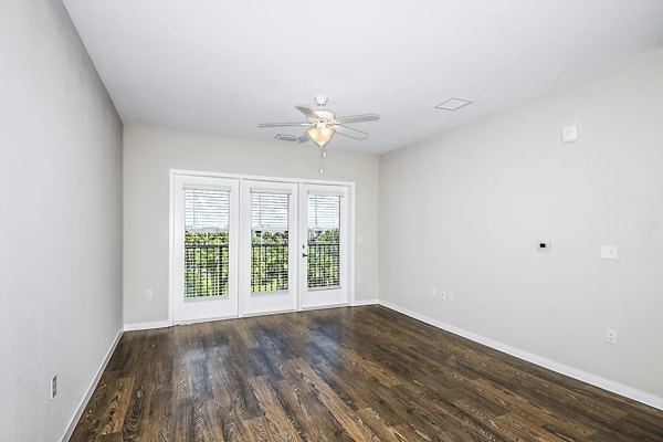 Spacious living room with modern furnishings in Parkside at Avalon Park Apartments