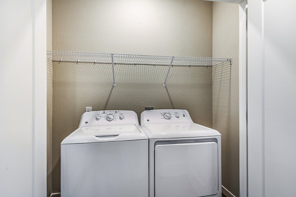 Laundry room with modern washers and dryers at Parkside at Avalon Park Apartments