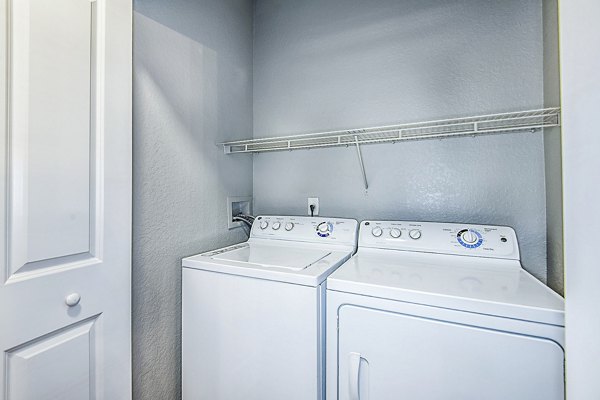 Laundry room with modern appliances at Parkside at Avalon Park Apartments, offering convenient living in luxury apartments