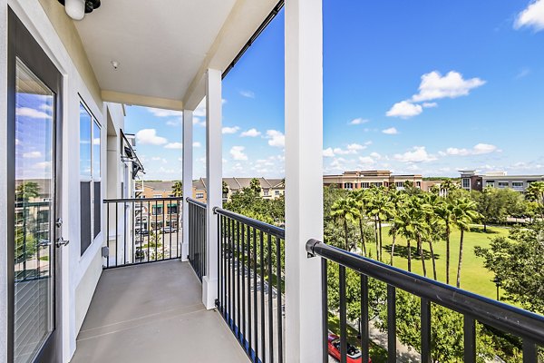 Cozy patio at Parkside at Avalon Park Apartments with lush greenery and seating area for relaxation