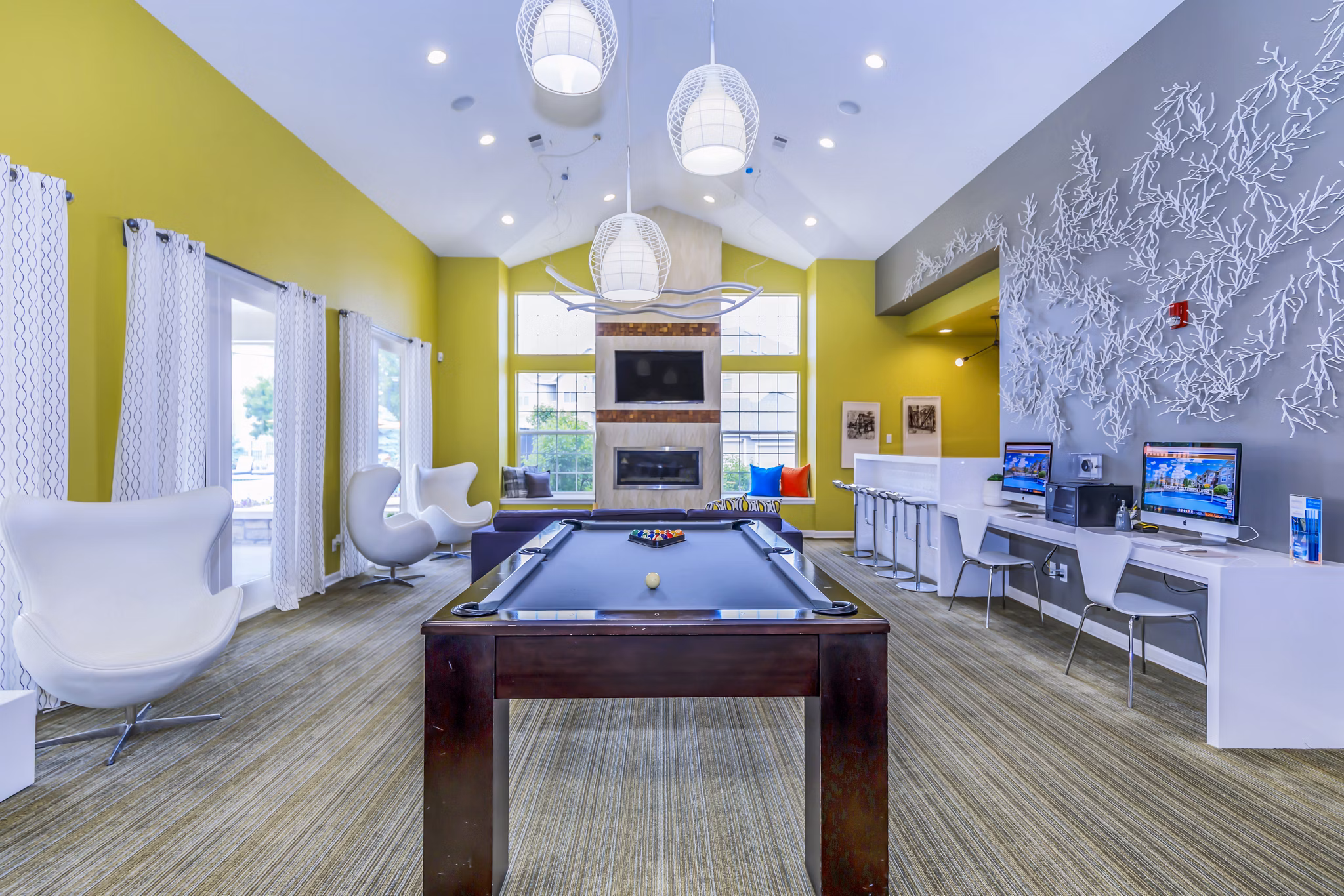 Clubhouse and game room featuring pool table and modern seating at Links at Legacy Ridge Apartments