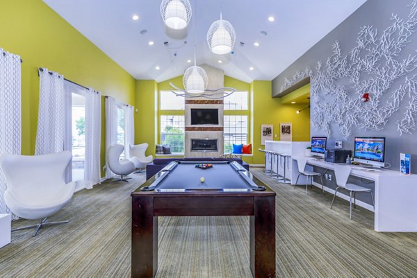 Clubhouse and game room featuring pool table and modern seating at Links at Legacy Ridge Apartments