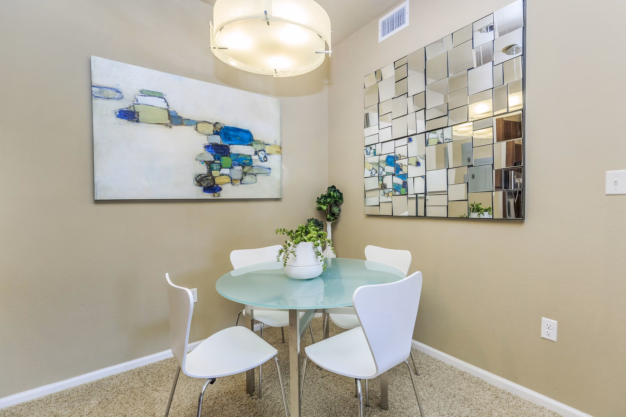 Dining room with elegant lighting and modern furnishings at Links at Legacy Ridge Apartments