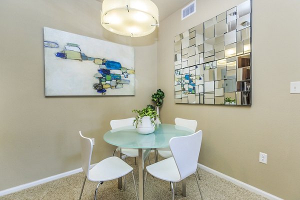 Dining room with elegant lighting and modern furnishings at Links at Legacy Ridge Apartments