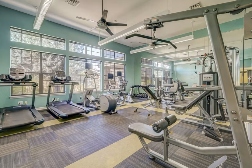 Modern yoga/spin studio with mirrored walls at Links at Legacy Ridge Apartments