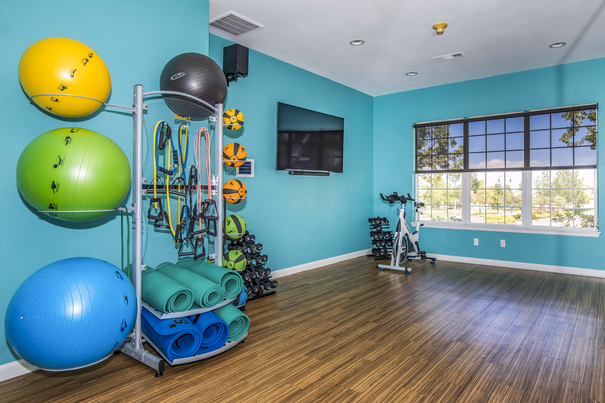 Modern yoga/spin studio with mirrored walls at Links at Legacy Ridge Apartments