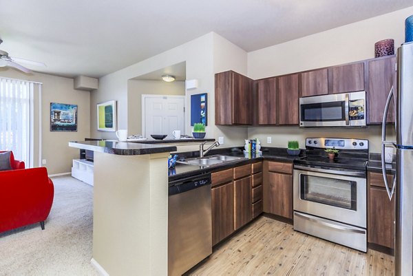 Modern kitchen with stainless steel appliances at Links at Legacy Ridge Apartments
