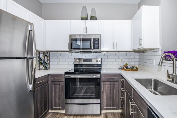 Modern kitchen with stainless steel appliances at Links at Legacy Ridge Apartments