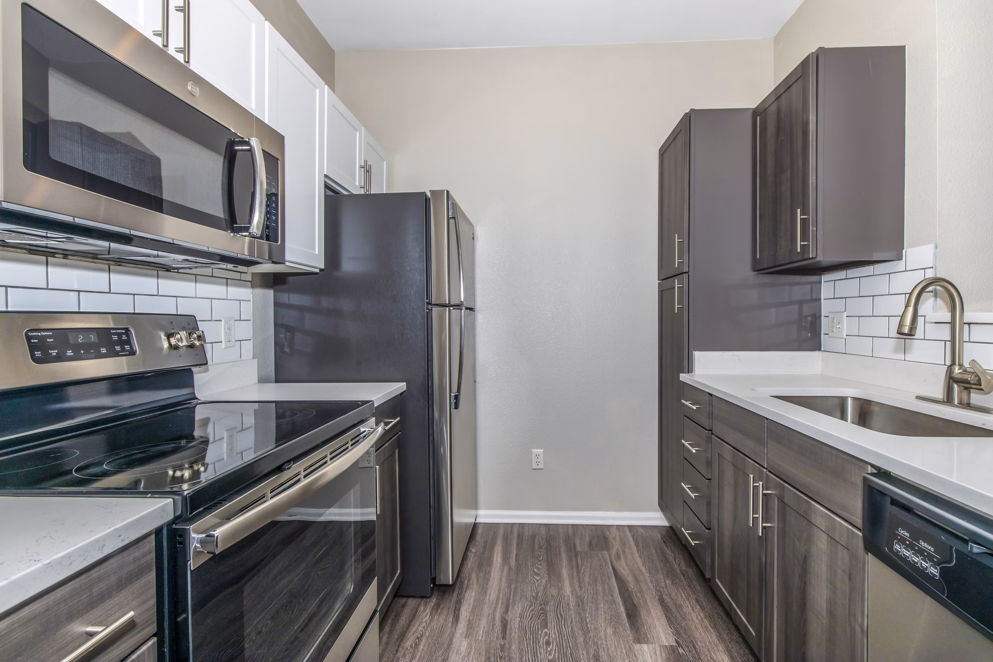 Sleek kitchen with granite countertops and modern appliances at Links at Legacy Ridge Apartments