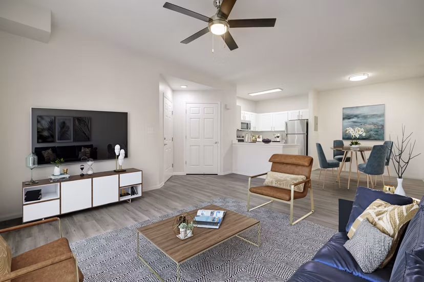 Living room with modern decor and large windows at Links at Legacy Ridge Apartments