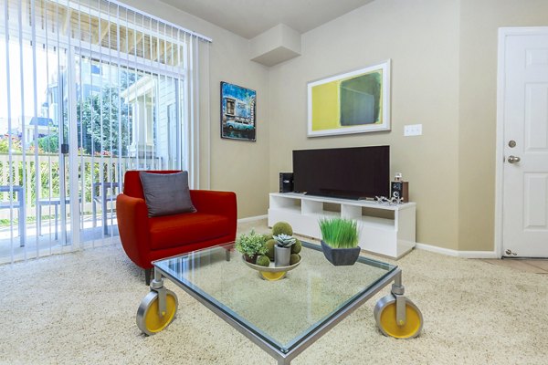 Cozy living room with elegant furnishings and ample natural light at Links at Legacy Ridge Apartments