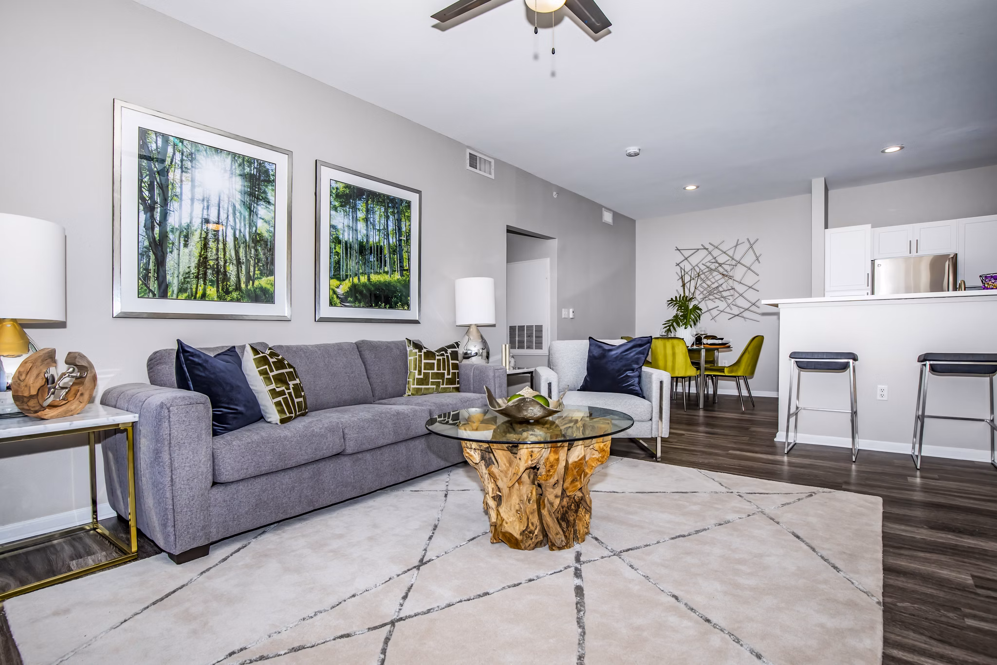 Modern living room with cozy furnishings and large windows at Links at Legacy Ridge Apartments in Westminster, CO.