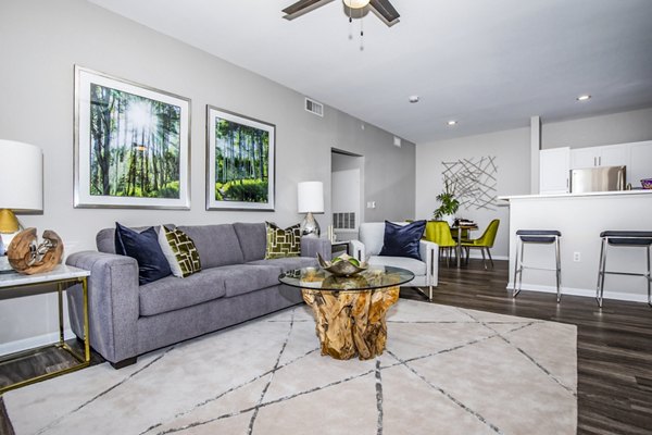 Modern living room with cozy furnishings and large windows at Links at Legacy Ridge Apartments in Westminster, CO.