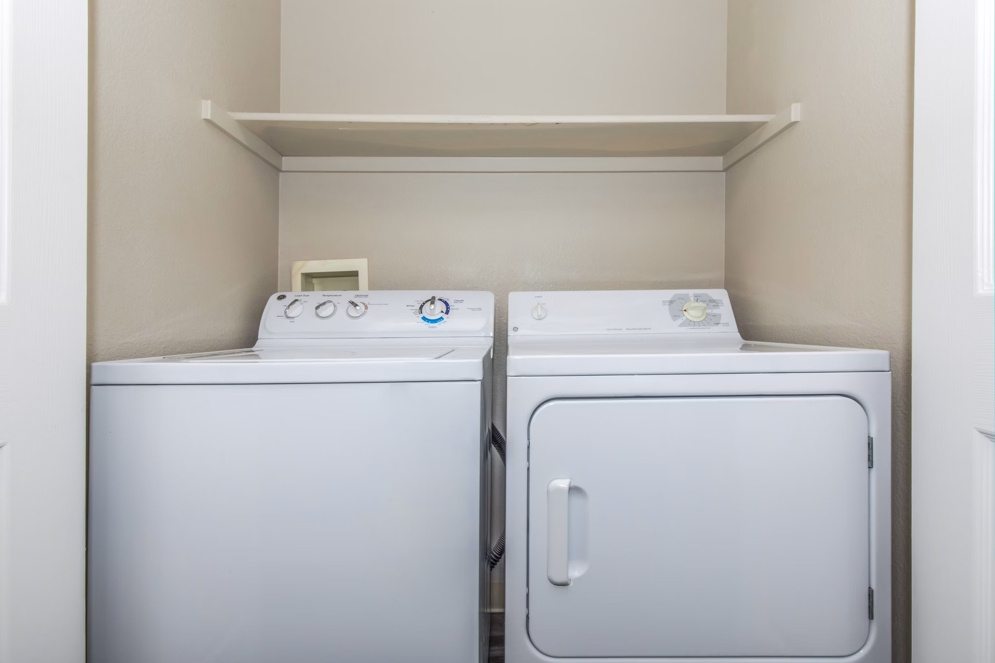 Convenient laundry room with modern appliances at Links at Legacy Ridge Apartments, a luxury community by Greystar