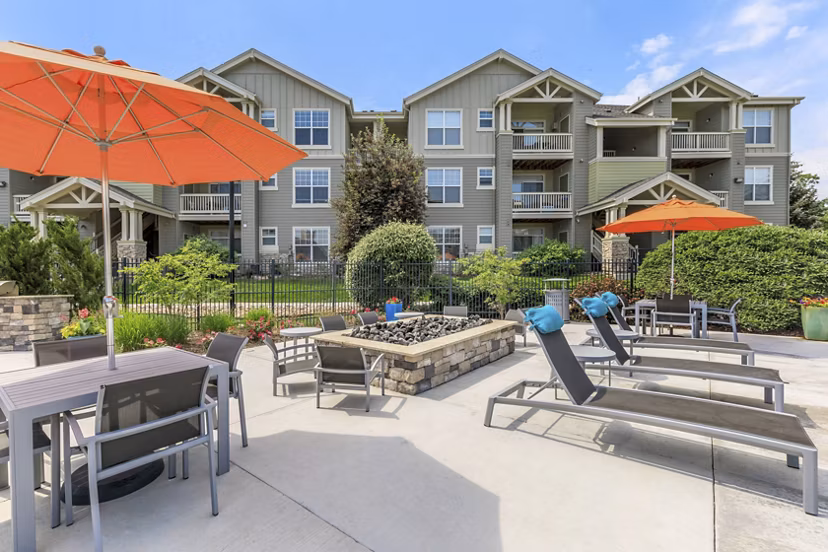 Patio with game area at Links at Legacy Ridge Apartments: Enjoy outdoor leisure and entertainment in our luxury community spaces
