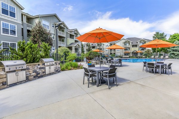 Outdoor grill area at Links at Legacy Ridge Apartments offering communal cooking space and seating