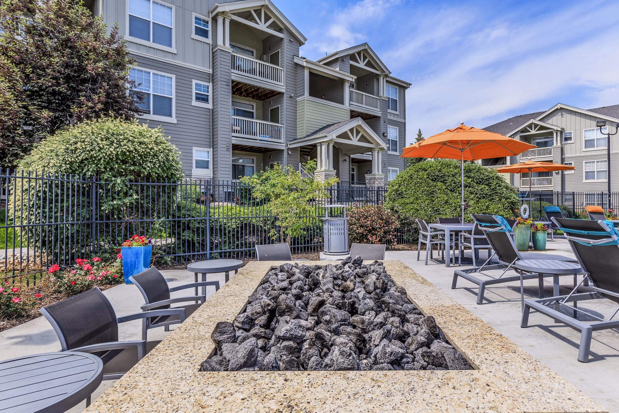 Cozy fire pit seating area at Links at Legacy Ridge Apartments