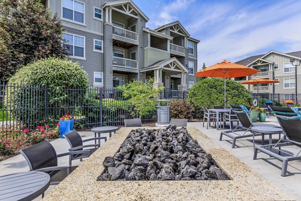 Cozy fire pit seating area at Links at Legacy Ridge Apartments