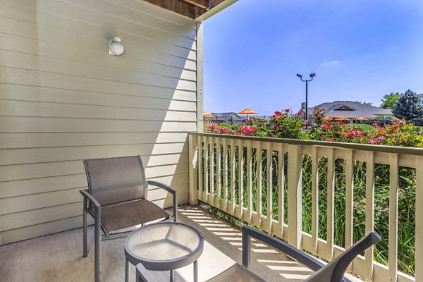Patio with stylish outdoor seating at Links at Legacy Ridge Apartments offering scenic views and relaxation space