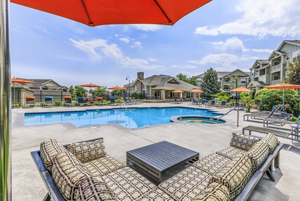 Outdoor pool oasis at Links at Legacy Ridge Apartments featuring luxurious seating and stunning landscaping for relaxation and entertainment
