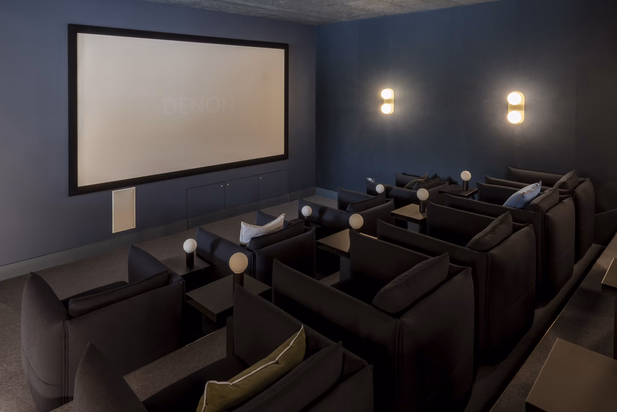 Luxurious private cinema room at Lyons Dock with comfortable seating and a large screen.