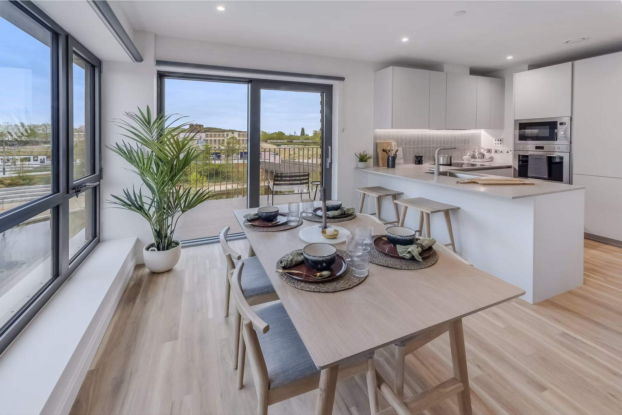 Contemporary kitchen and dining area at Lyons Dock with a large window offering scenic views.