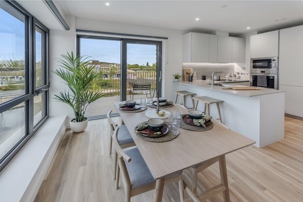 Contemporary kitchen and dining area at Lyons Dock with a large window offering scenic views.