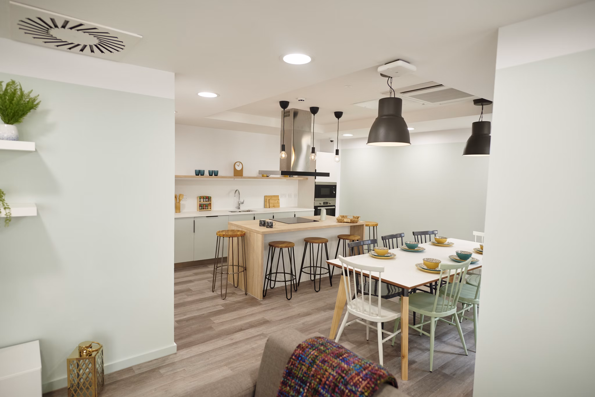 Bright and welcoming dining area at Canvas Bristol with a contemporary design and communal seating.