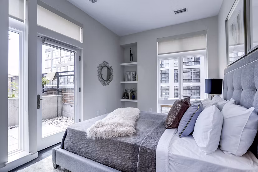 Cozy bedroom with modern decor at Brookland Press Apartments in Washington, DC, offering luxury living experiences