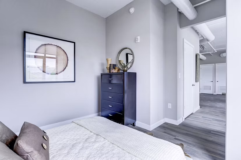 Cozy bedroom with modern decor at Brookland Press Apartments, luxury living space in a vibrant community