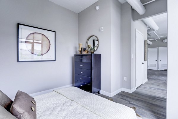 Cozy bedroom with modern decor at Brookland Press Apartments, luxury living space in a vibrant community