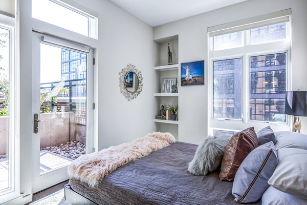 Modern bedroom with stylish decor at Brookland Press Apartments in Washington DC