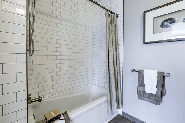 Modern bathroom with sleek fixtures and stylish vanity at Brookland Press Apartments