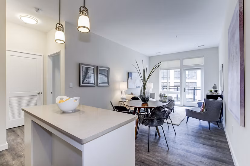 Dining room with modern lighting and stylish seating at Brookland Press Apartments