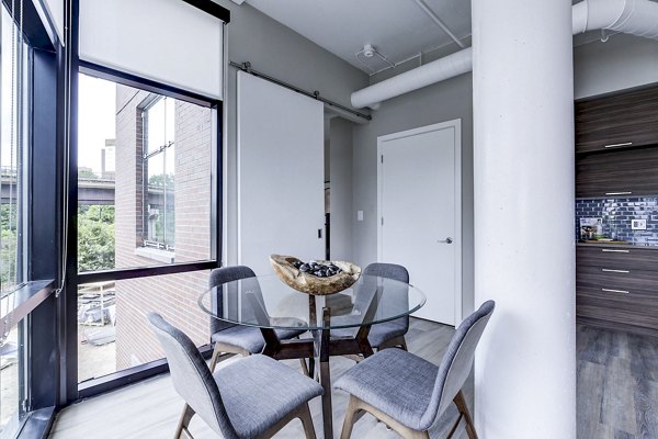 Dining room with modern decor and sleek furniture at Brookland Press Apartments