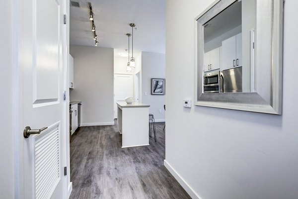 Modern kitchen with stainless steel appliances at the entrance of Brookland Press Apartments
