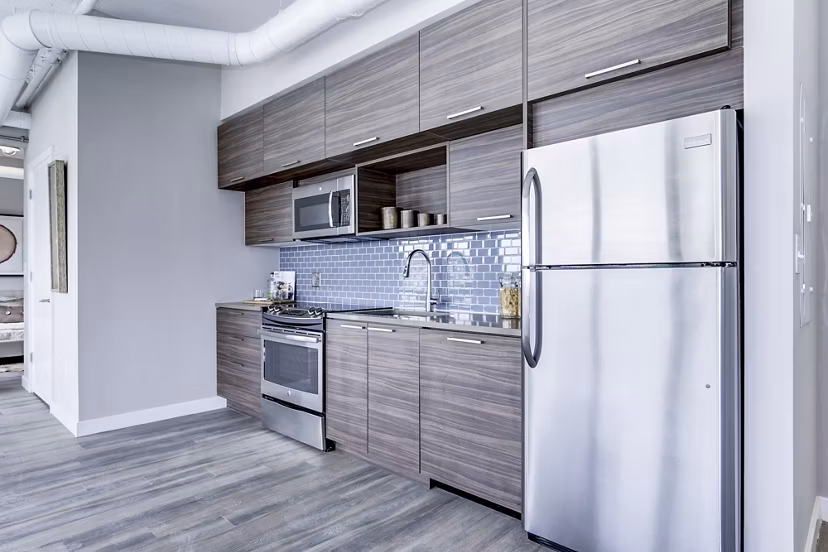Modern kitchen with stainless steel appliances and sleek countertops at Brookland Press Apartments