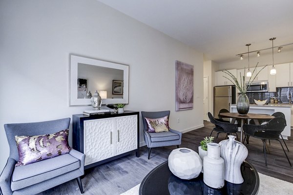 Contemporary living room featuring stylish furniture and artwork at Brookland Press Apartments in Washington, DC