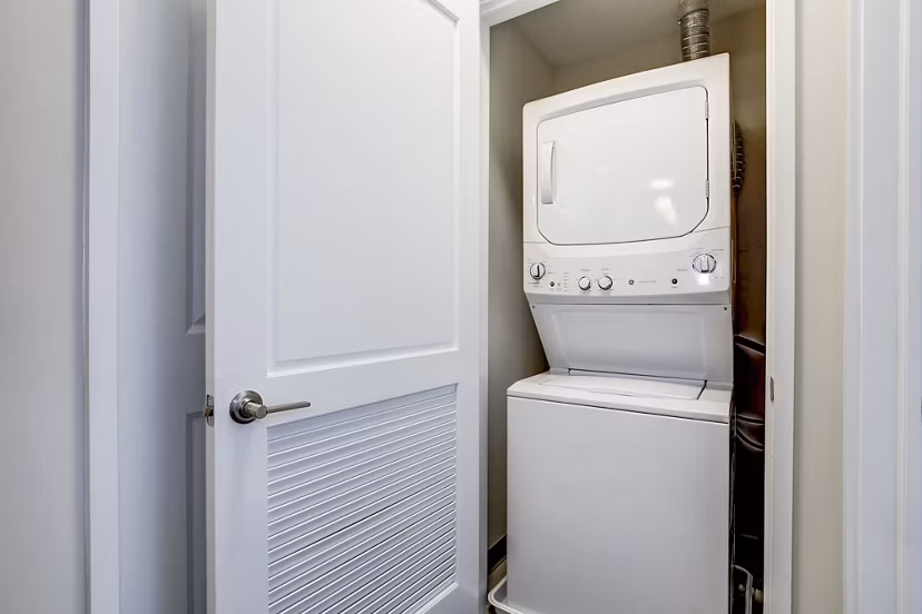 Laundry room with modern appliances at Brookland Press Apartments, luxury living with premier amenities in a stylish community
