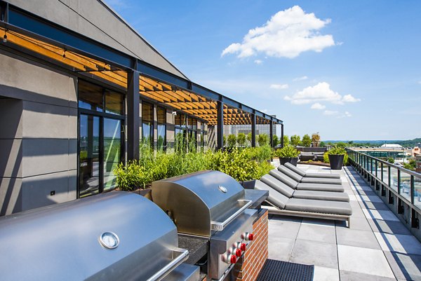 Spacious patio with modern grill area at Brookland Press Apartments