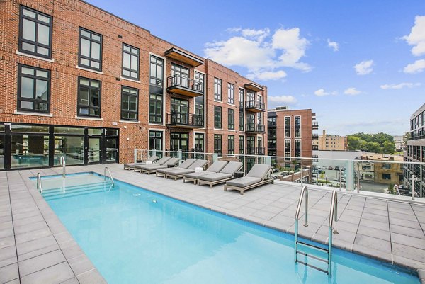 Rooftop pool with lounge seating at Brookland Press Apartments