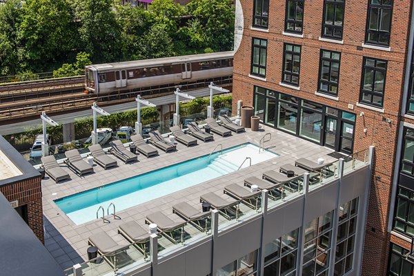 Modern swimming pool at Brookland Press Apartments with comfortable lounging areas
