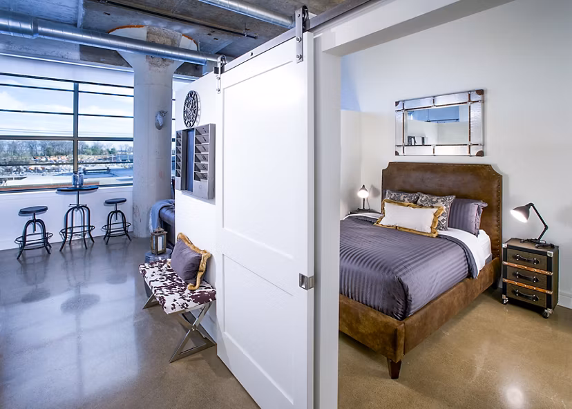 Cozy bedroom with industrial design elements at Hecht Warehouse Apartments