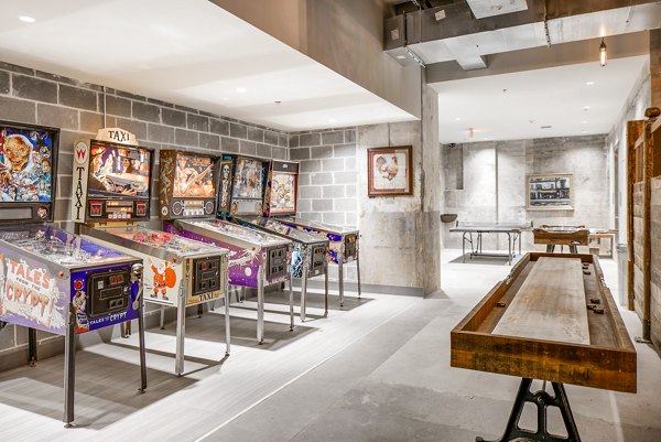 Clubhouse game room with entertainment options at Hecht Warehouse Apartments