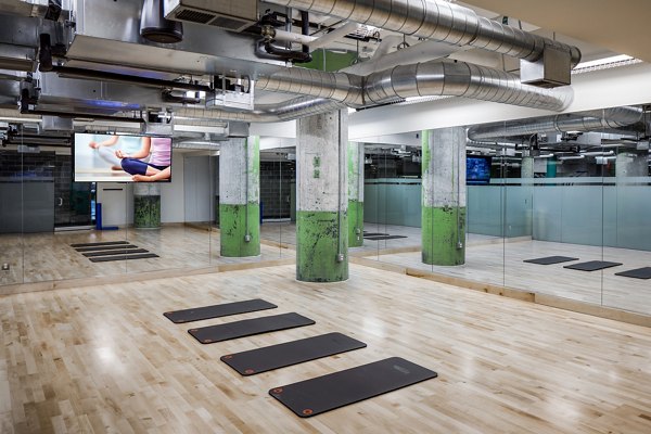 Yoga studio with natural light and mirrored walls at Hecht Warehouse Apartments