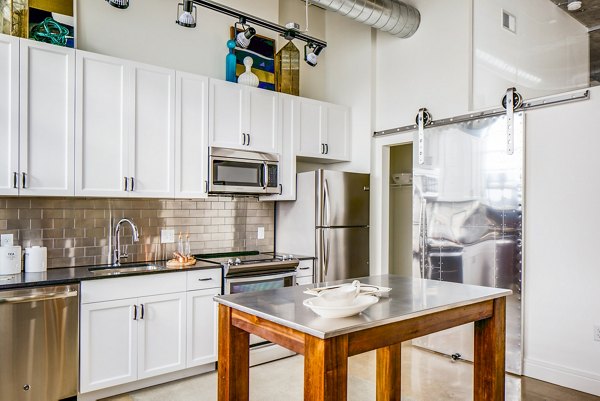 Modern kitchen with stainless steel appliances at Hecht Warehouse Apartments, offering luxurious living spaces in Washington DC